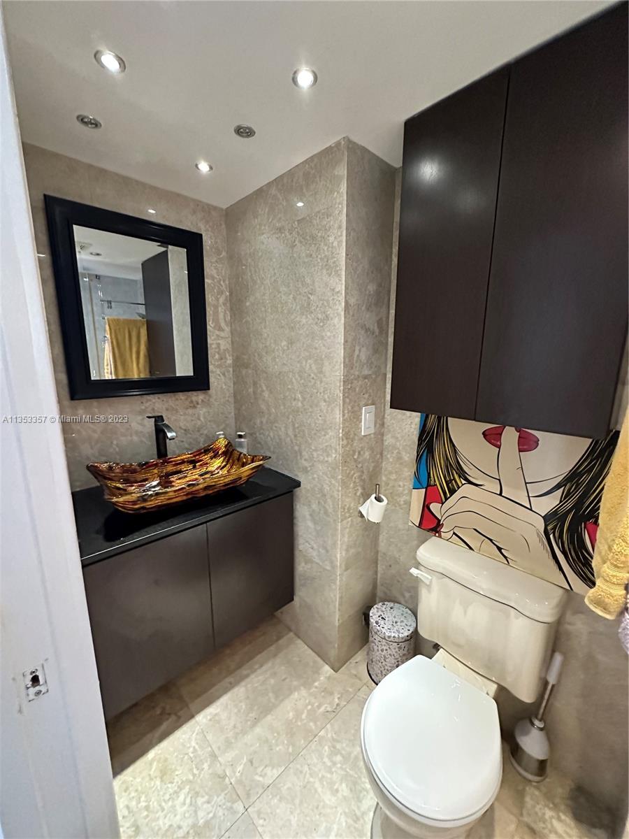 200 Southeast 15th Road, Unit 5J Miami, FL 33129 - Photo 20 of 20 a bathroom with a sink vanity mirror and toilet