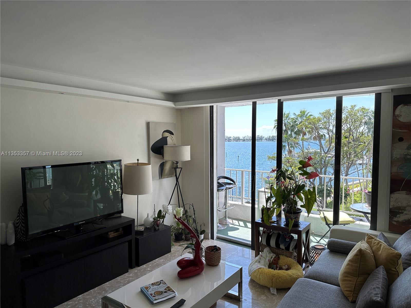 200 Southeast 15th Road, Unit 5J Miami, FL 33129 - Photo 2 of 20 a living room with furniture and a flat screen tv