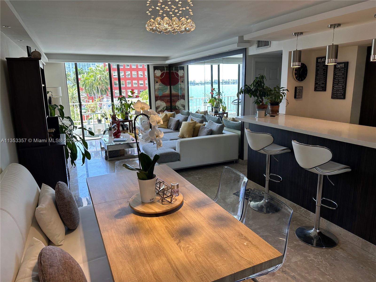 200 Southeast 15th Road, Unit 5J Miami, FL 33129 - Photo 3 of 20 a living room with furniture kitchen view and a large window