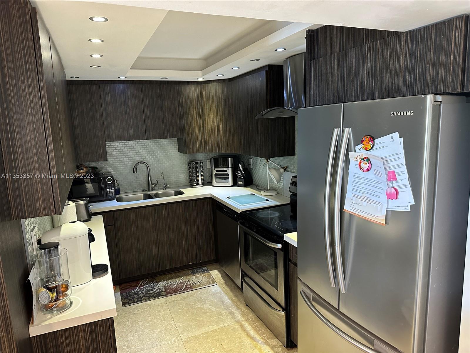 200 Southeast 15th Road, Unit 5J Miami, FL 33129 - Photo 5 of 20 a kitchen with stainless steel appliances a refrigerator and a stove