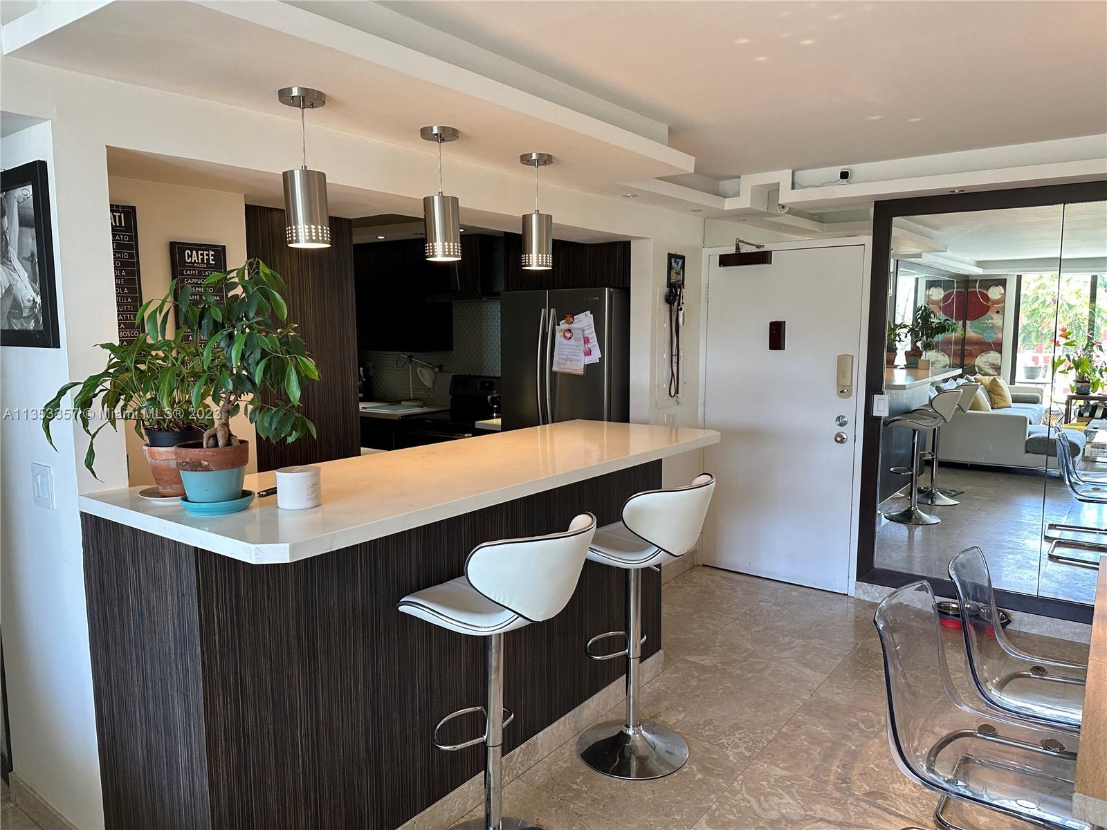 200 Southeast 15th Road, Unit 5J Miami, FL 33129 - Photo 7 of 20 a kitchen with a table and chairs in it