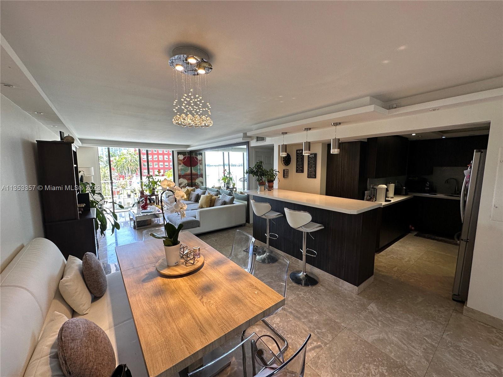 200 Southeast 15th Road, Unit 5J Miami, FL 33129 - Photo 9 of 20 a living room with furniture a dining table and chairs