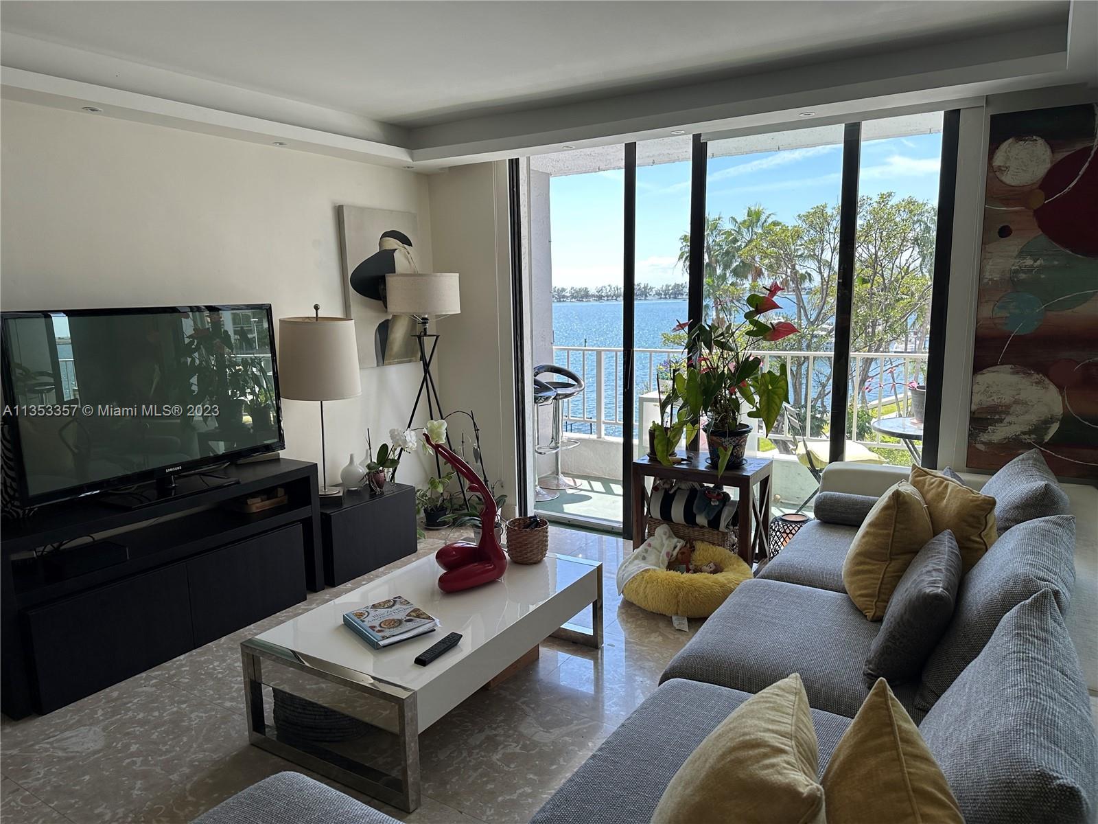 200 Southeast 15th Road, Unit 5J Miami, FL 33129 - Photo 10 of 20 a living room with furniture and a floor to ceiling window