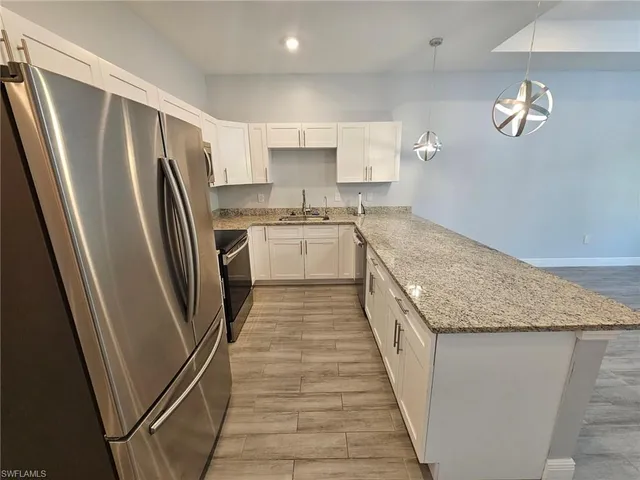 a kitchen with stove a sink and refrigerator