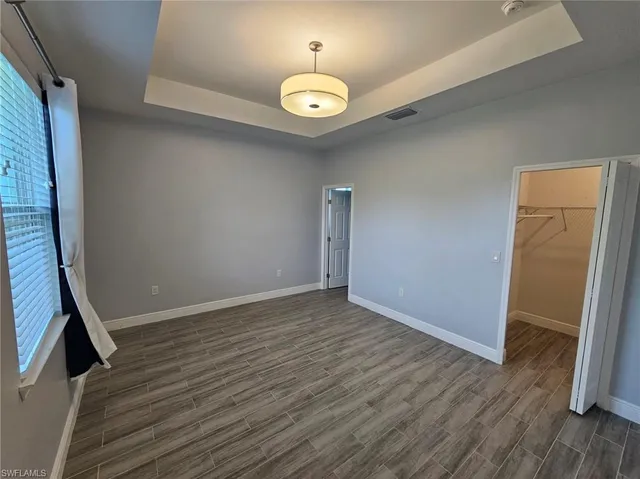 a kitchen with stainless steel appliances granite countertop a stove a sink and a wooden floors