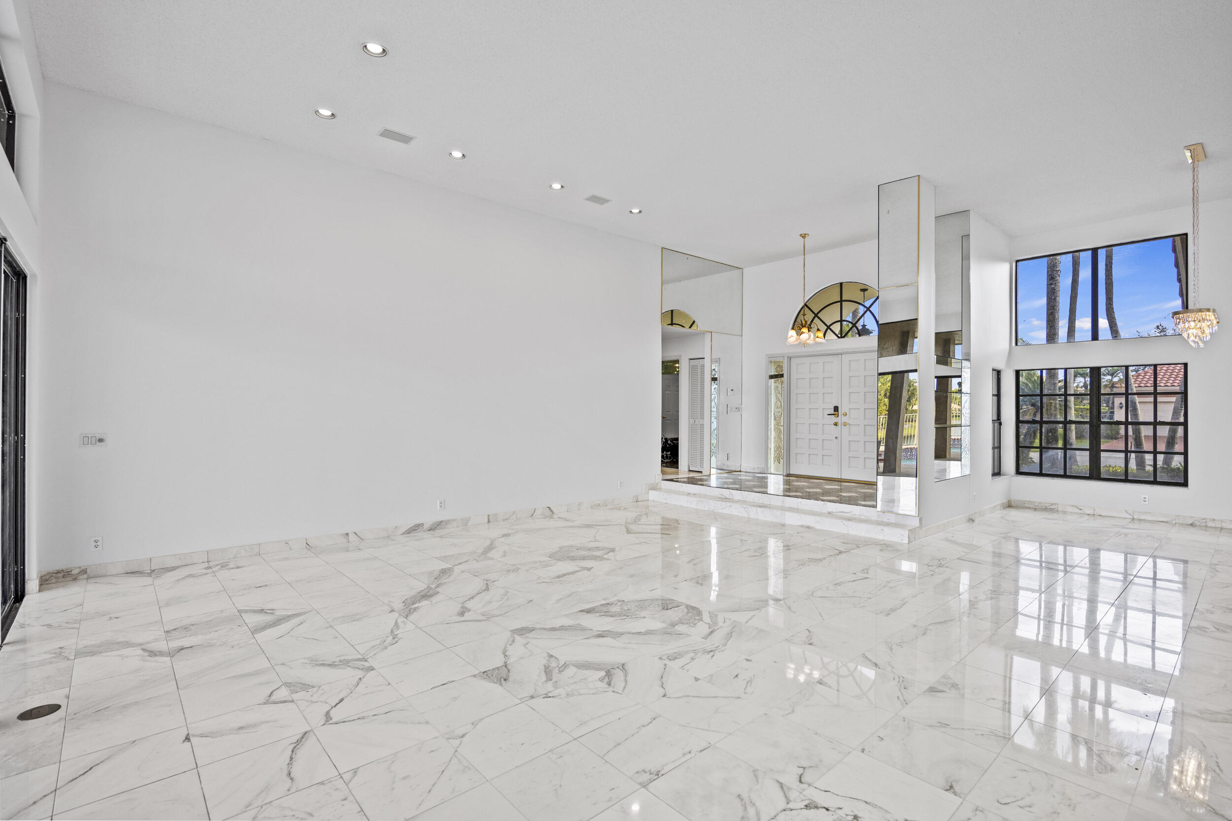 10747 Stonebridge Boulevard Boca Raton, FL 33498 - Photo 13 of 81 a view of a livingroom with wooden floor and chandelier