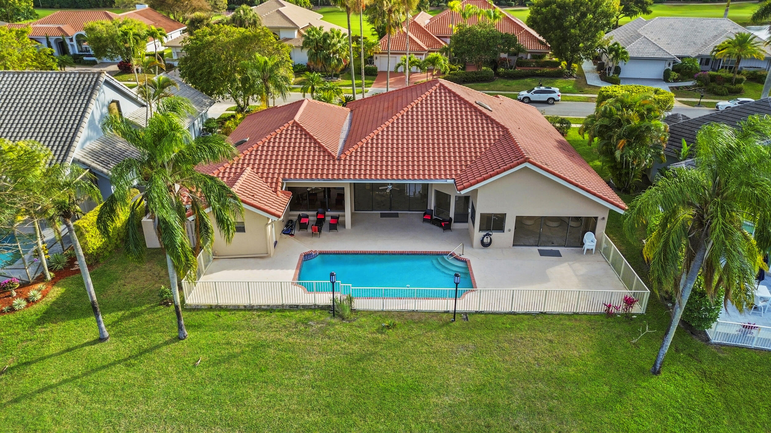 10747 Stonebridge Boulevard Boca Raton, FL 33498 - Photo 2 of 81 a front view of house with yard and green space