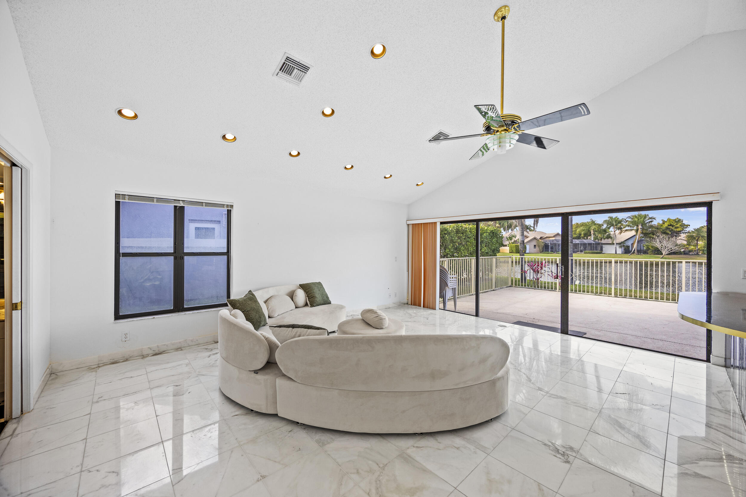 10747 Stonebridge Boulevard Boca Raton, FL 33498 - Photo 27 of 81 a living room with furniture and a floor to ceiling window