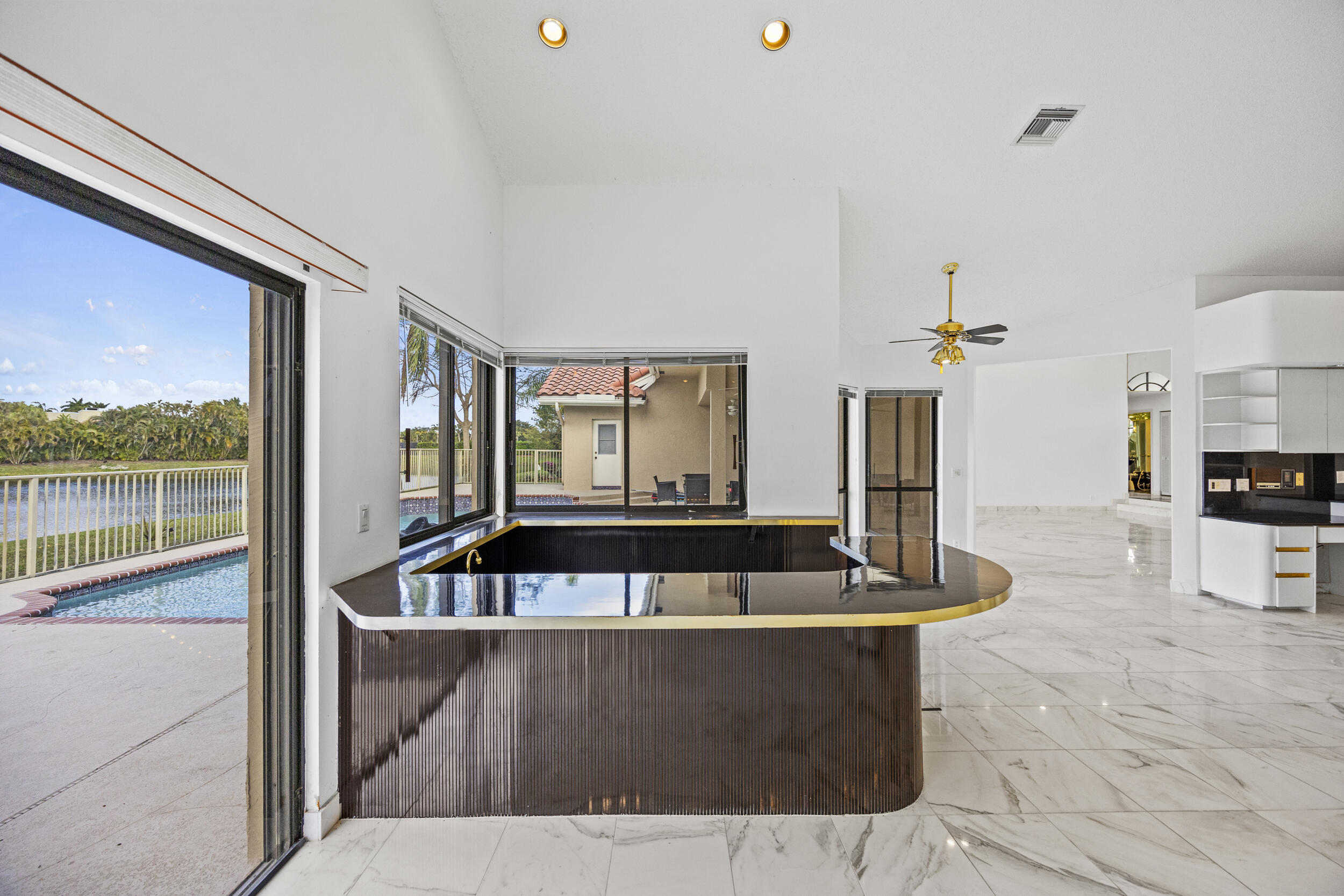 10747 Stonebridge Boulevard Boca Raton, FL 33498 - Photo 30 of 81 a living room with furniture a flat screen tv and a large window