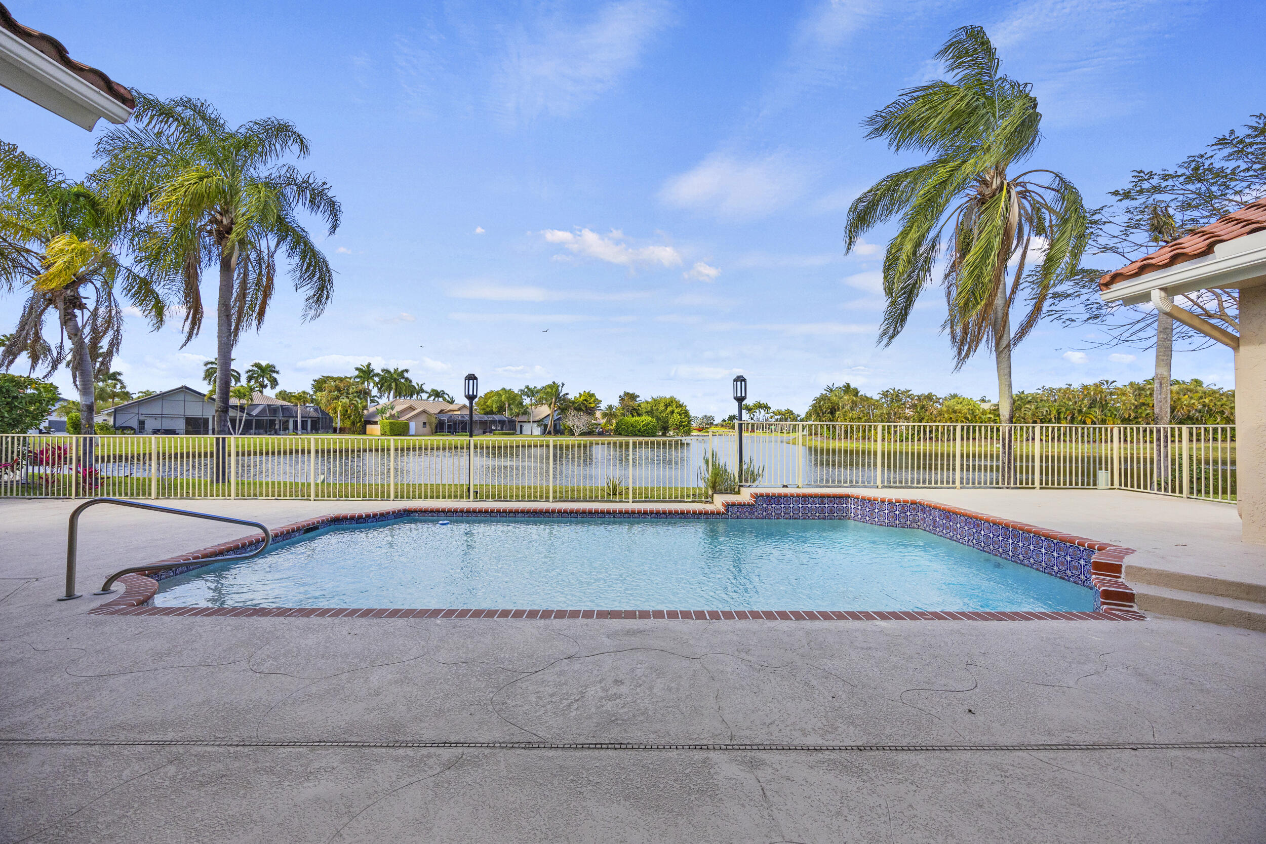 10747 Stonebridge Boulevard Boca Raton, FL 33498 - Photo 3 of 81 a view of a swimming pool with a lounge chairs