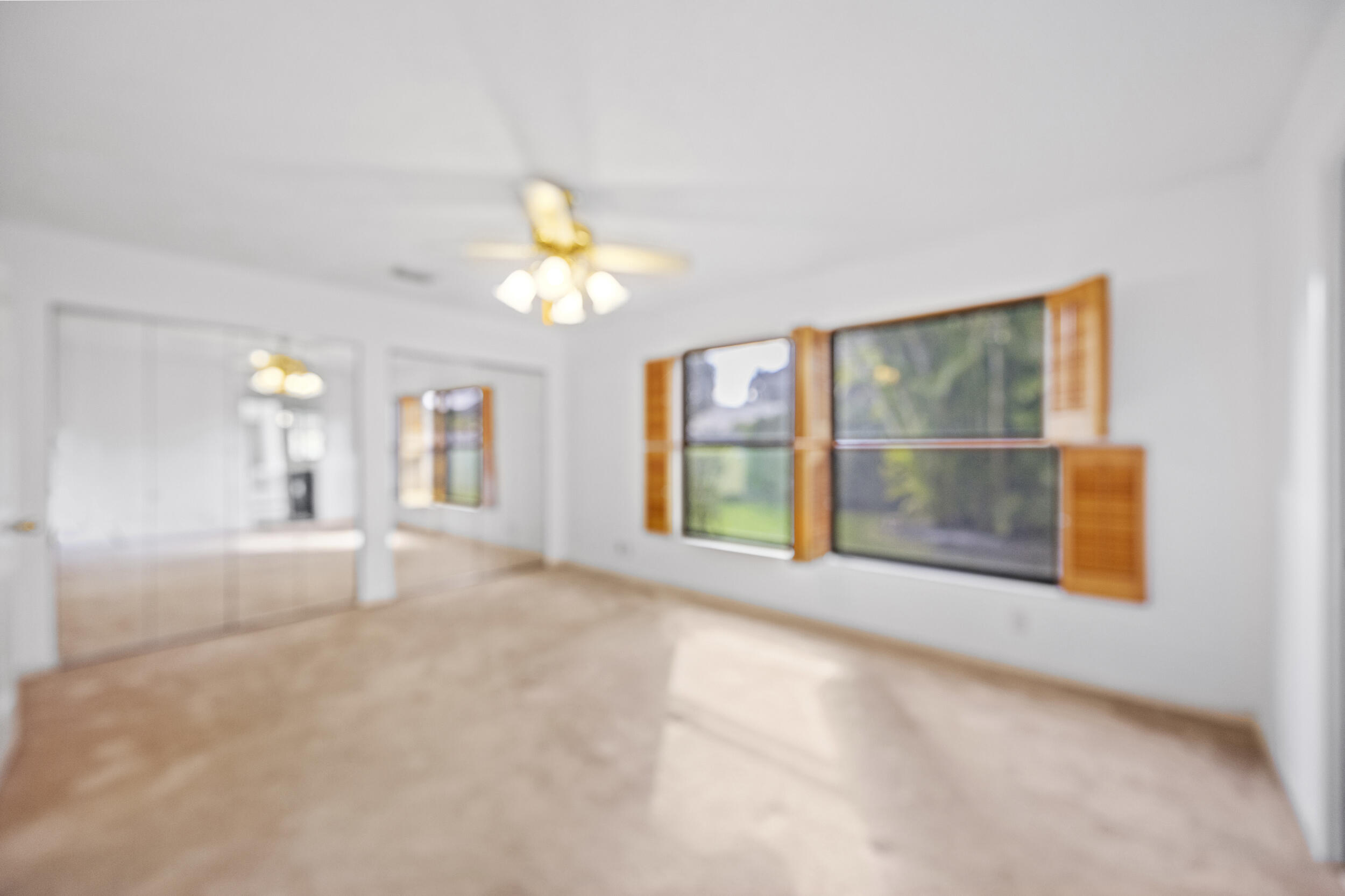 10747 Stonebridge Boulevard Boca Raton, FL 33498 - Photo 37 of 81 a view of an empty room with a window and a kitchen area