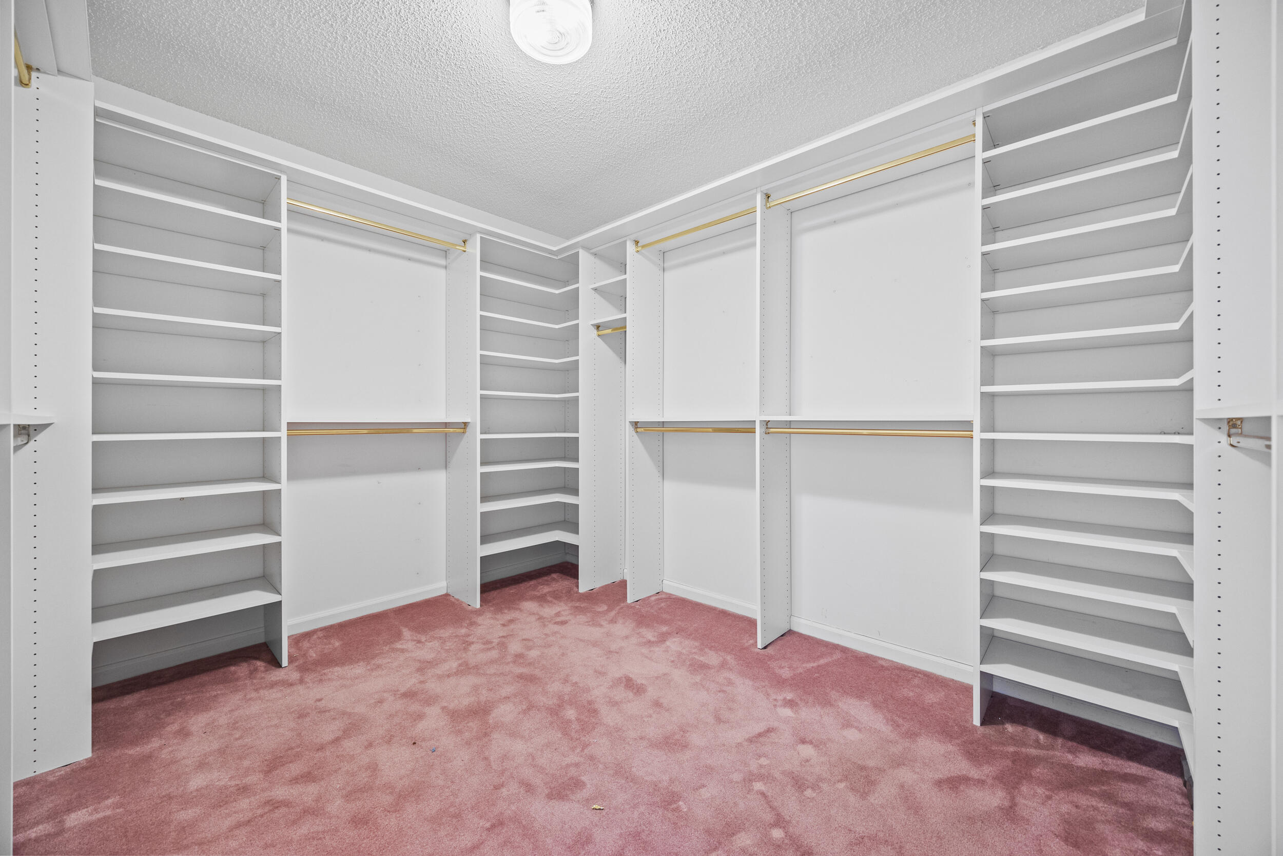 10747 Stonebridge Boulevard Boca Raton, FL 33498 - Photo 39 of 81 a view of walk in closet with empty racks