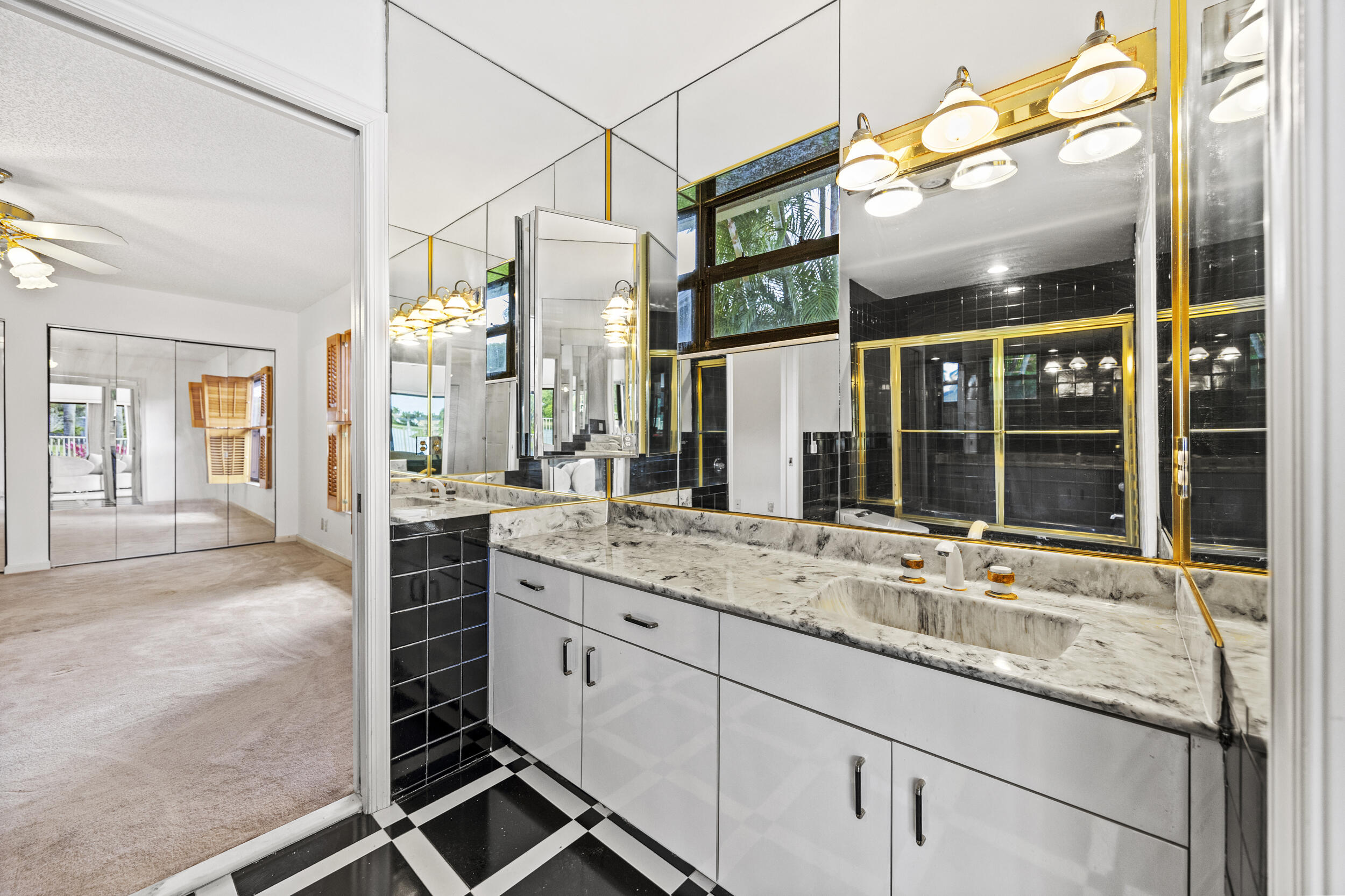 10747 Stonebridge Boulevard Boca Raton, FL 33498 - Photo 47 of 81 a bathroom with a granite countertop sink and a large mirror
