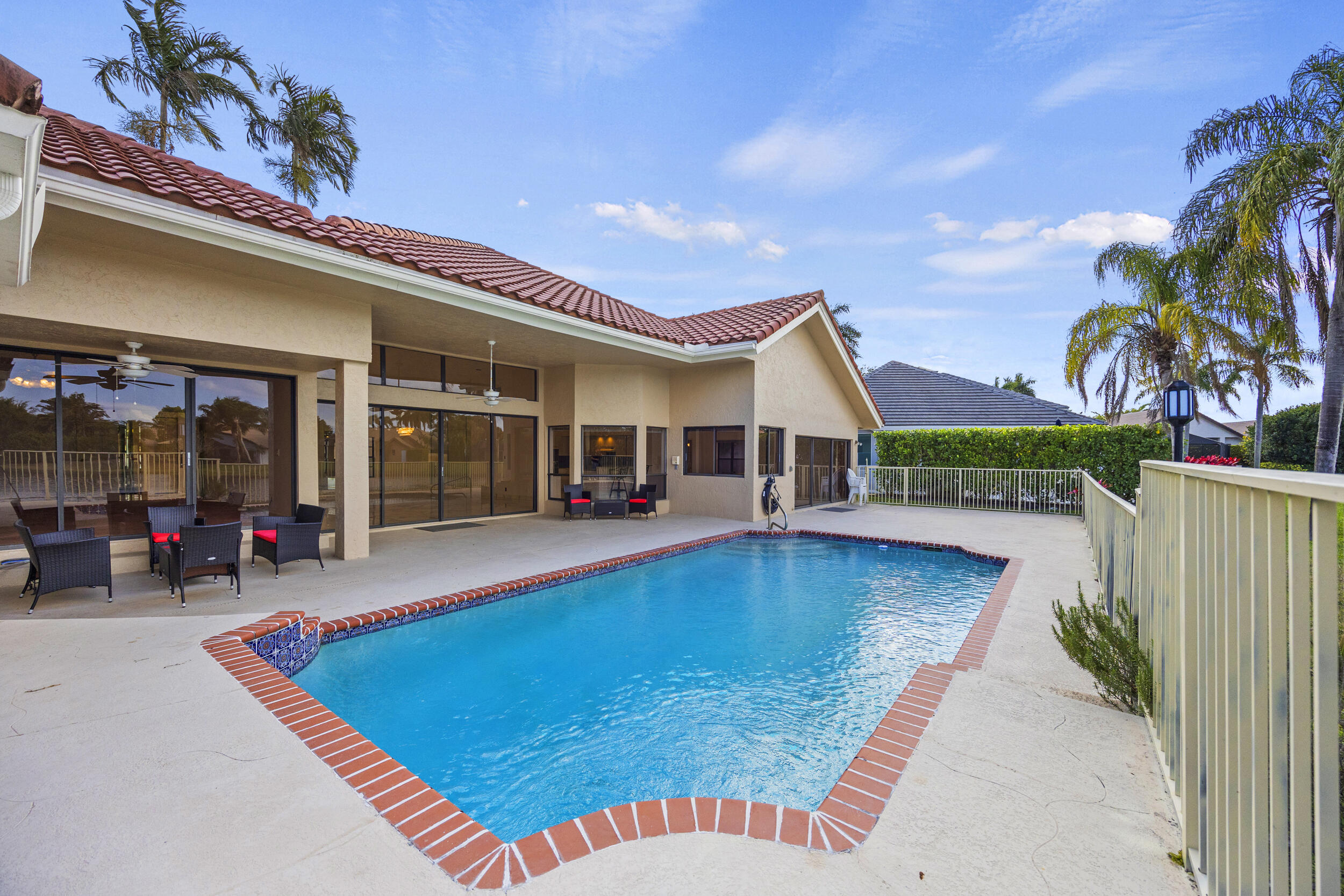 10747 Stonebridge Boulevard Boca Raton, FL 33498 - Photo 53 of 81 a view of a house with swimming pool and sitting area