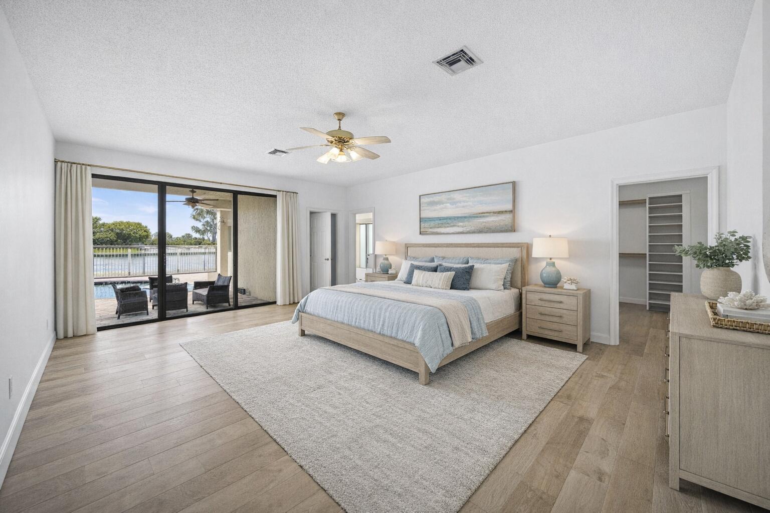 10747 Stonebridge Boulevard Boca Raton, FL 33498 - Photo 9 of 81 a spacious bedroom with a large bed and a chandelier