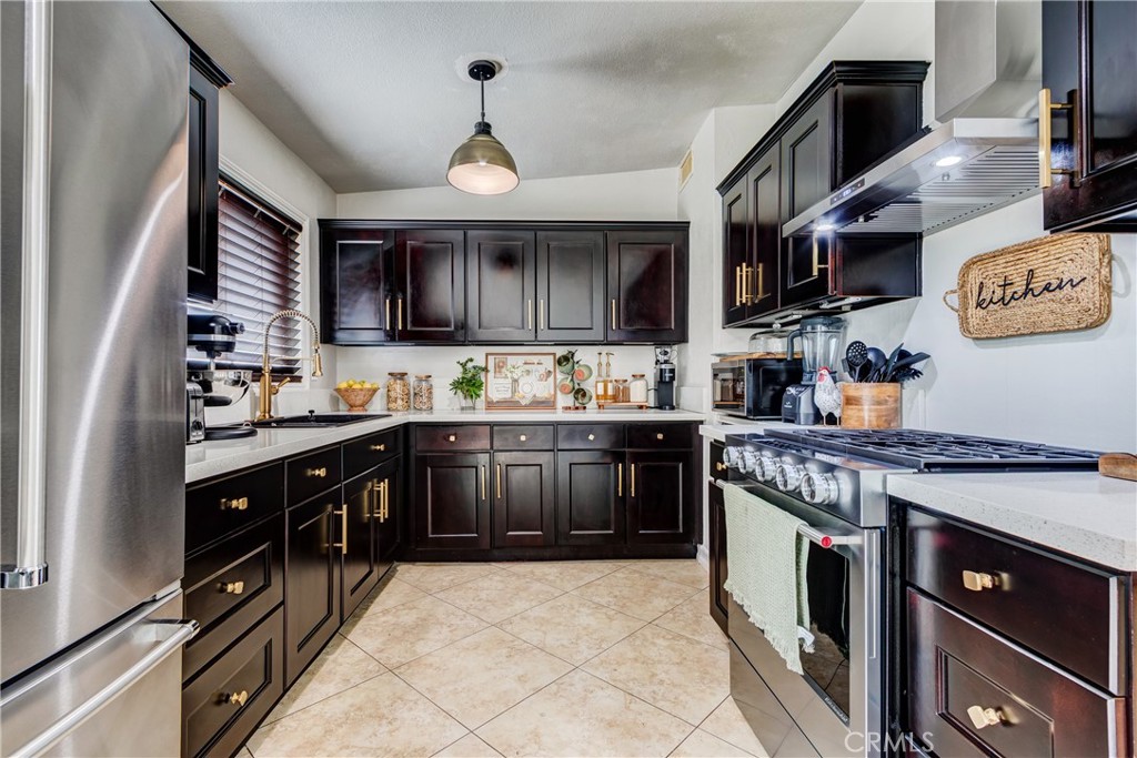 a kitchen with stainless steel appliances granite countertop a stove sink and cabinets
