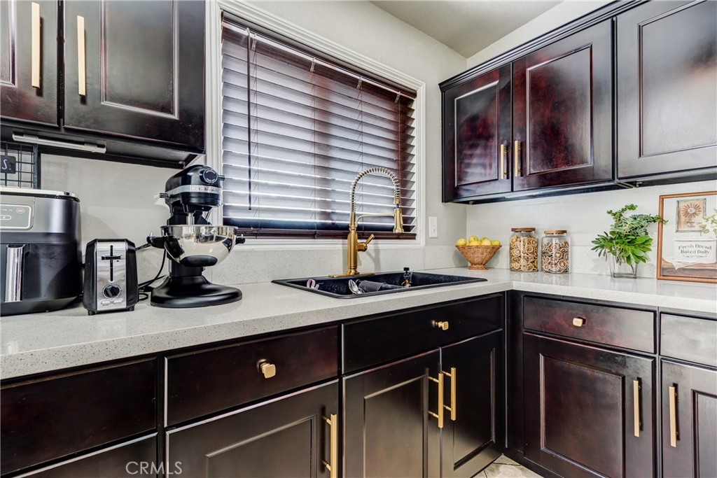 6688 Phoenix Avenue Riverside, CA 92504 - Photo 11 of 26 a kitchen with stainless steel appliances granite countertop a sink and wooden cabinets