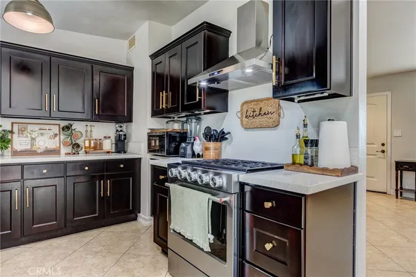 a kitchen with stainless steel appliances granite countertop a stove and a sink