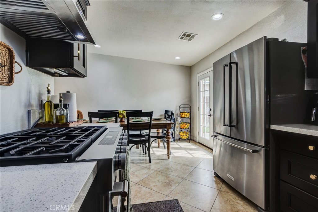 6688 Phoenix Avenue Riverside, CA 92504 - Photo 13 of 26 a kitchen with stainless steel appliances a refrigerator and a stove top oven