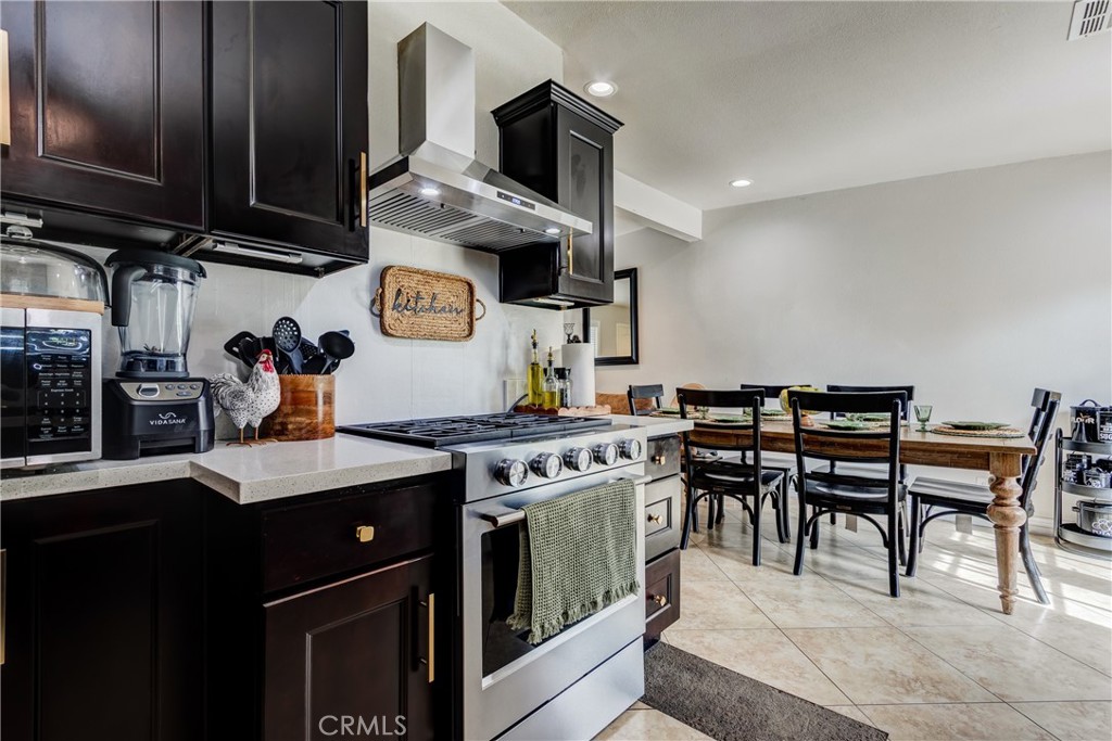 6688 Phoenix Avenue Riverside, CA 92504 - Photo 14 of 26 a kitchen with stainless steel appliances granite countertop a stove a sink dishwasher and cabinets with wooden floor