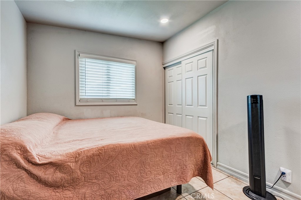 6688 Phoenix Avenue Riverside, CA 92504 - Photo 19 of 26 a bedroom with a bed and a flat screen tv