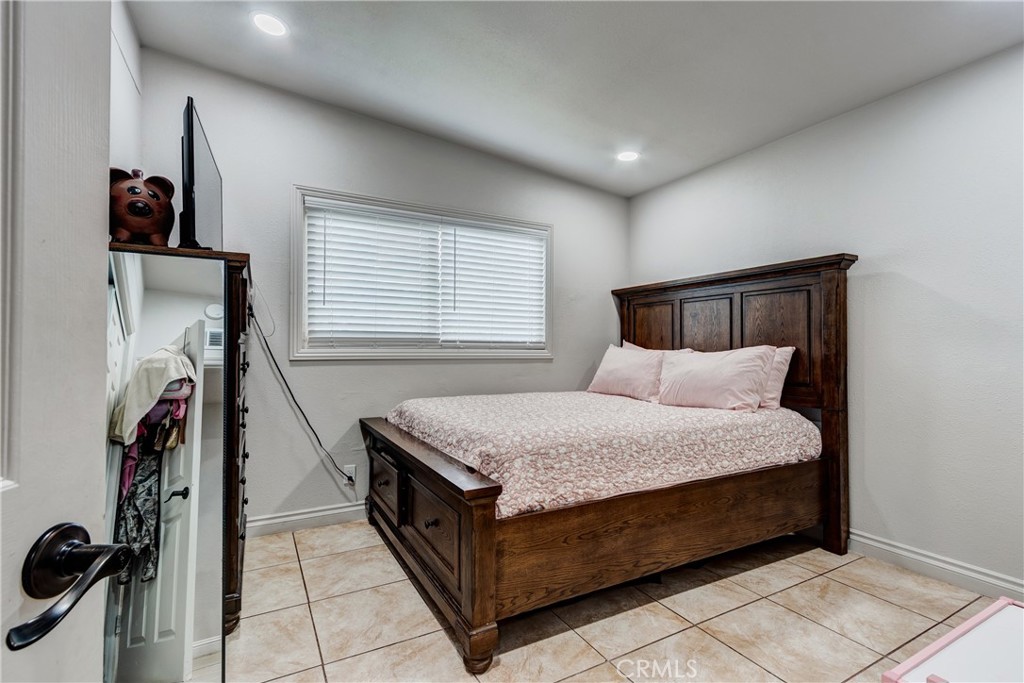 6688 Phoenix Avenue Riverside, CA 92504 - Photo 20 of 26 a bed room with a bed and a window