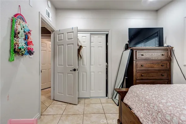 a bedroom with a bed and a flat tv screen