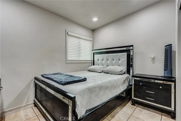 a bedroom with a bed and a dresser