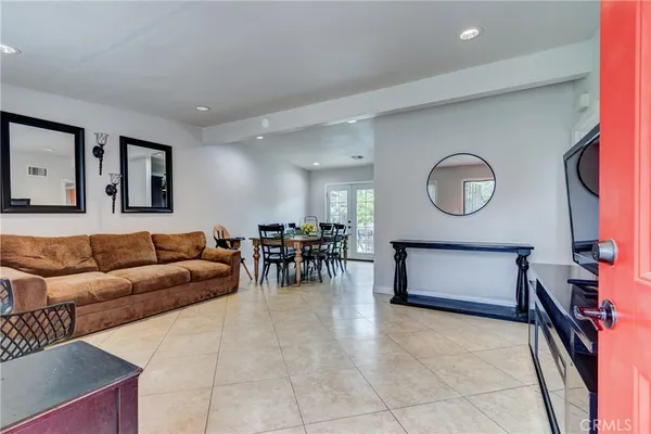 a living room with furniture and a mirror