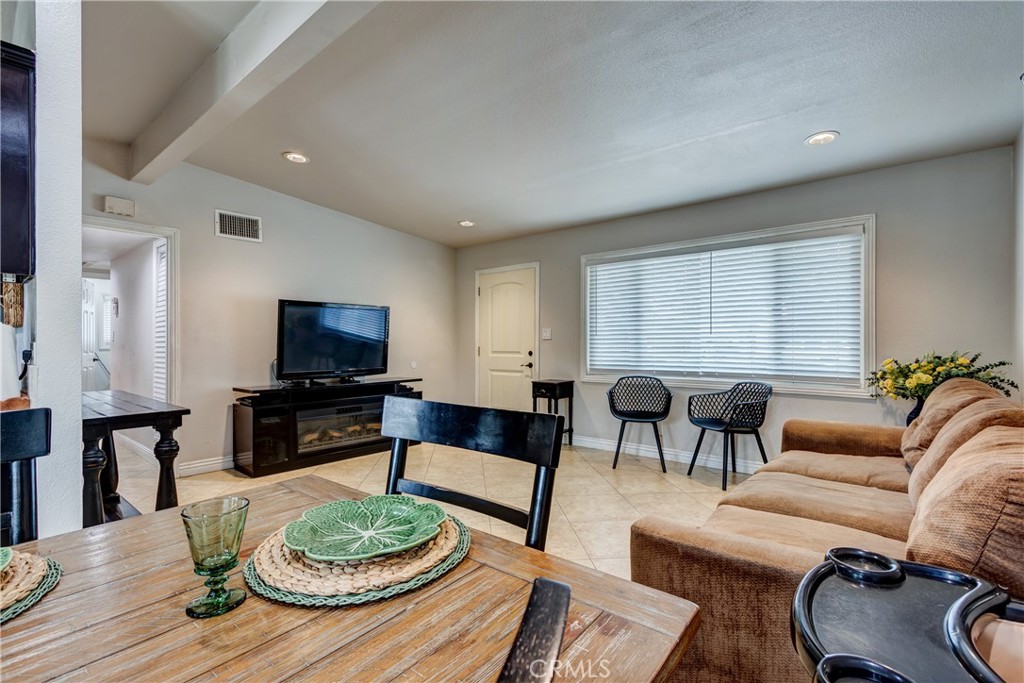 6688 Phoenix Avenue Riverside, CA 92504 - Photo 7 of 26 a living room with furniture a fireplace and a flat screen tv