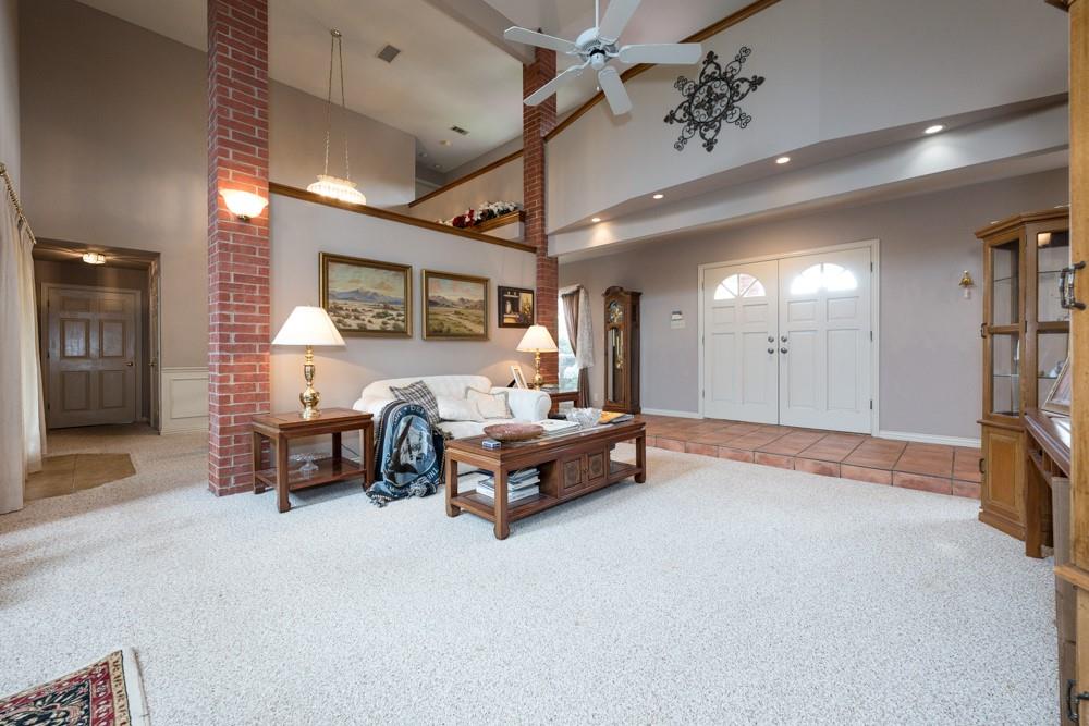 9554 David Fort Road Argyle, TX 76226 - Photo 17 of 35 a spacious bedroom with a bed and a chandelier
