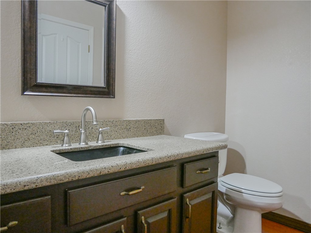 2575 Triangle S Street Kingman, AZ 86401 - Photo 19 of 45 a bathroom with a granite countertop toilet sink and mirror