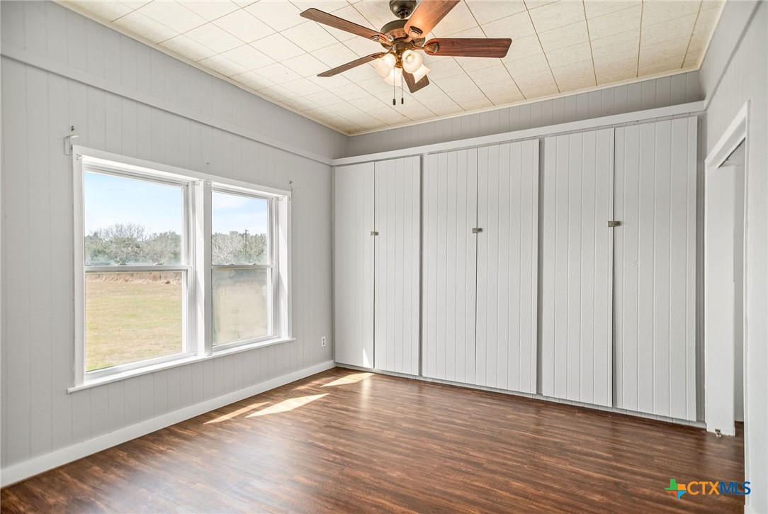 303 Garcitas Grove Road Inez, TX 77968 - Photo 12 of 39 a view of an empty room with a window and wooden floor