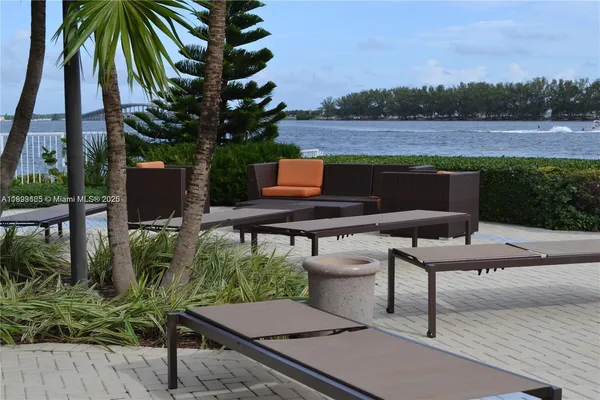 a view of a backyard with sitting area