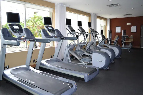 a room with gym equipment and a large window