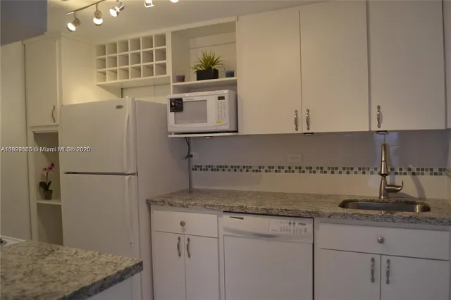a kitchen with a sink and refrigerator