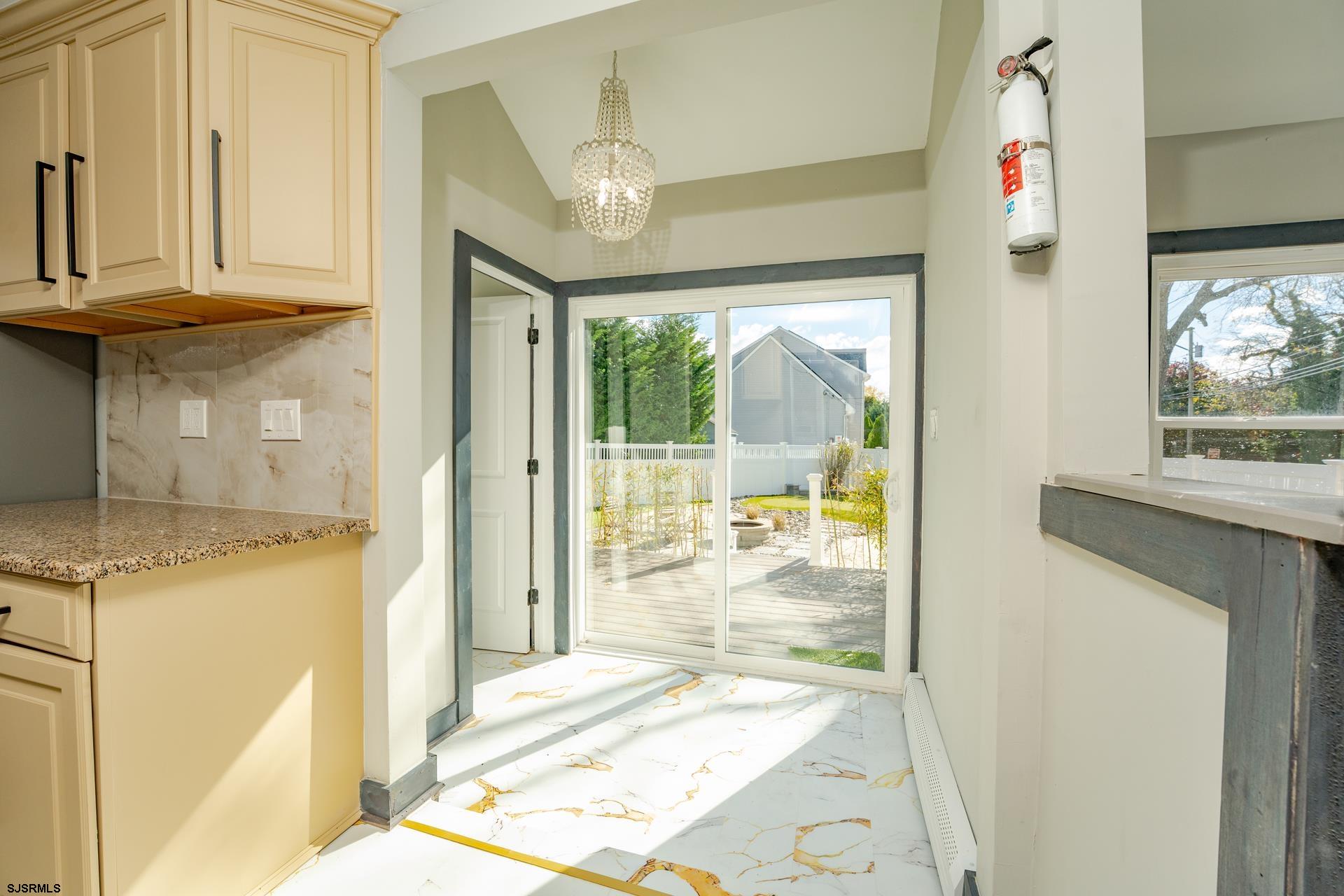1203 West Mill Road Northfield, NJ 08225 - Photo 15 of 90 a view of a hallway with wooden floor and a kitchen view