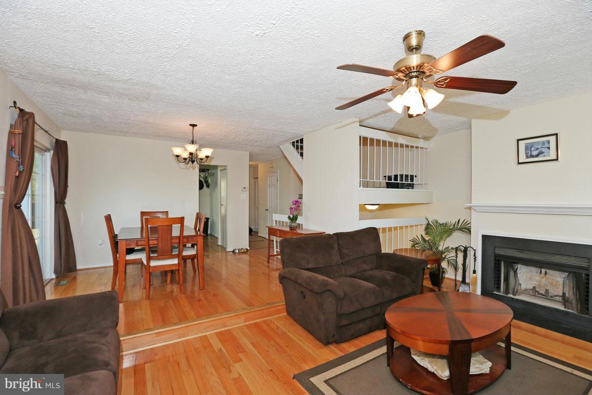 1816 Windjammer Way Gaithersburg, MD 20879 - Photo 11 of 29 a living room with furniture a fireplace and a flat screen tv