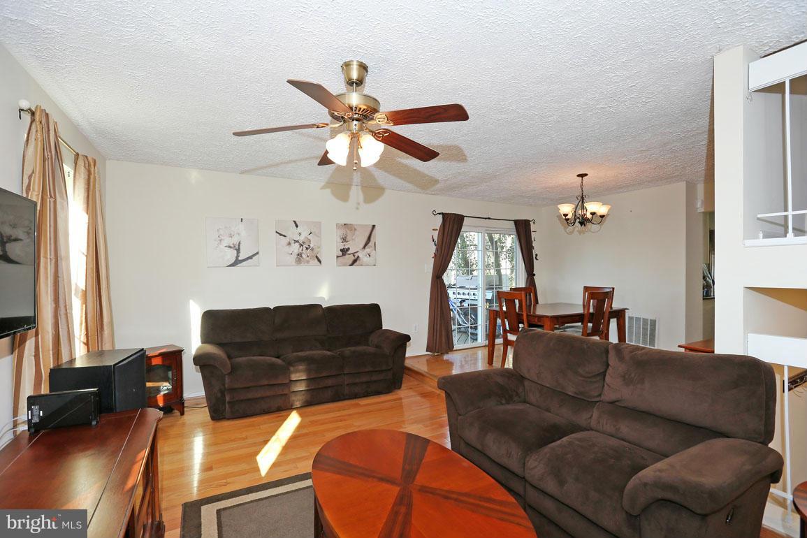 1816 Windjammer Way Gaithersburg, MD 20879 - Photo 12 of 29 a living room with furniture ceiling fan and a window