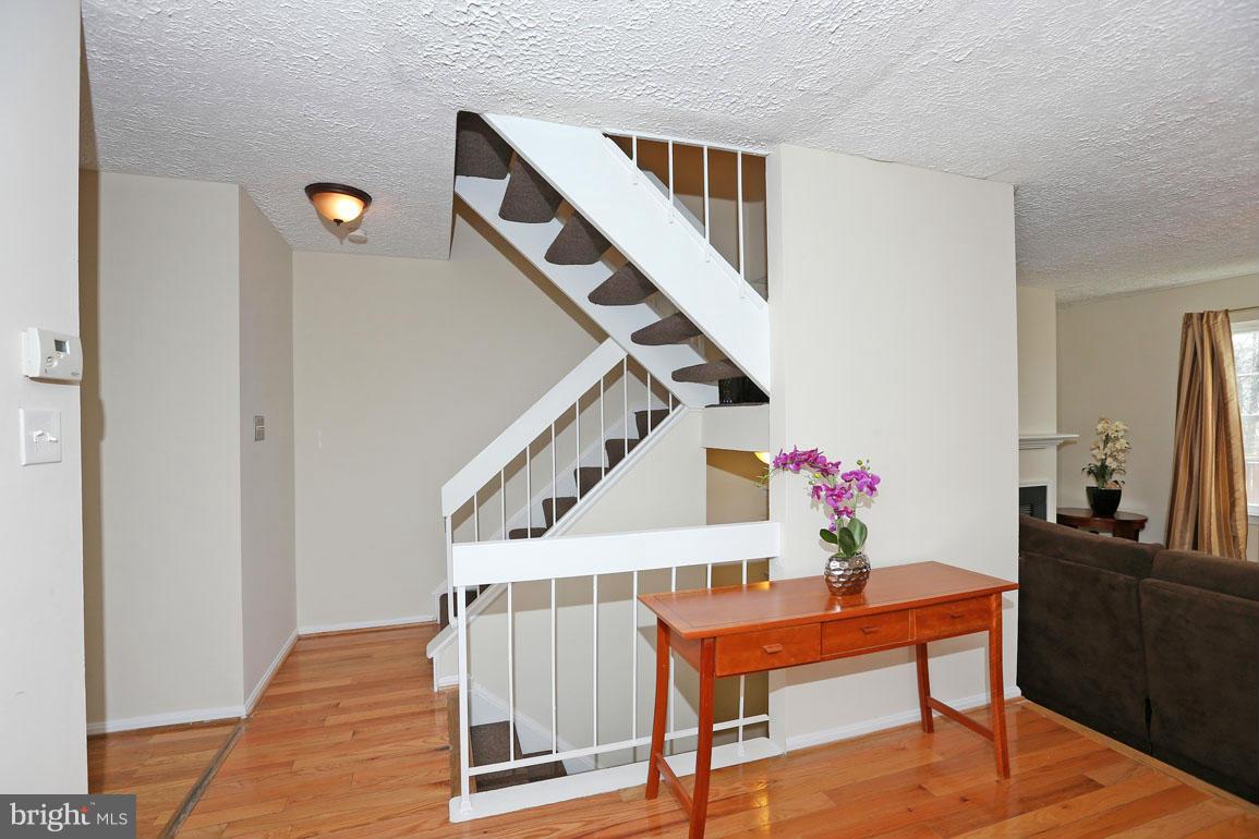 1816 Windjammer Way Gaithersburg, MD 20879 - Photo 14 of 29 a hallway with furniture and wooden floor