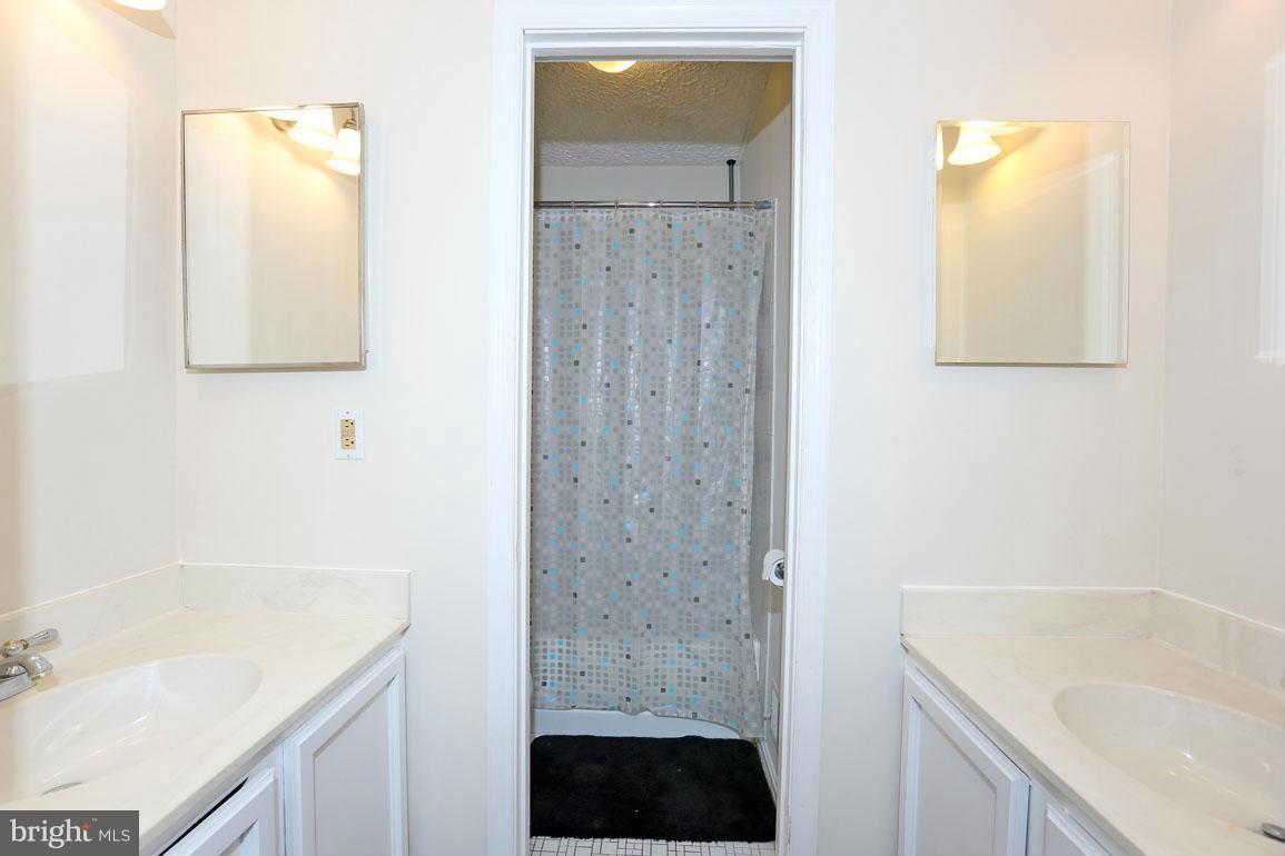 1816 Windjammer Way Gaithersburg, MD 20879 - Photo 17 of 29 a bathroom with a sink a shower and a bathtub