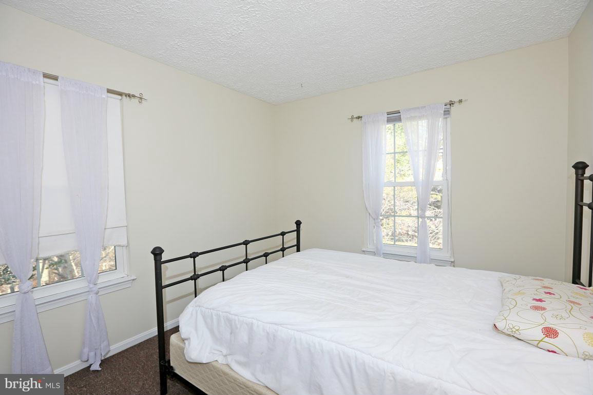 1816 Windjammer Way Gaithersburg, MD 20879 - Photo 18 of 29 a bedroom with a bed and a window