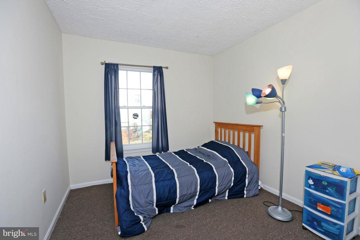1816 Windjammer Way Gaithersburg, MD 20879 - Photo 19 of 29 a bed sitting in a bedroom next to a window