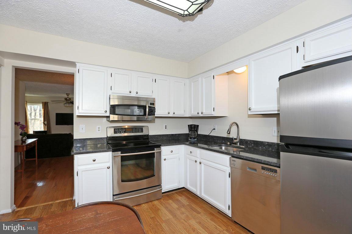 1816 Windjammer Way Gaithersburg, MD 20879 - Photo 3 of 29 a kitchen with stainless steel appliances granite countertop a stove a sink and a refrigerator