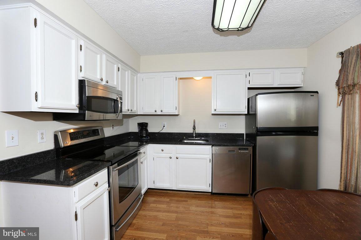 1816 Windjammer Way Gaithersburg, MD 20879 - Photo 4 of 29 a kitchen with a refrigerator and a stove top oven