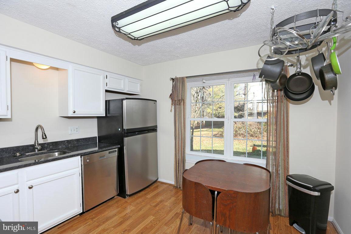 1816 Windjammer Way Gaithersburg, MD 20879 - Photo 5 of 29 a kitchen with a refrigerator and a stove top oven