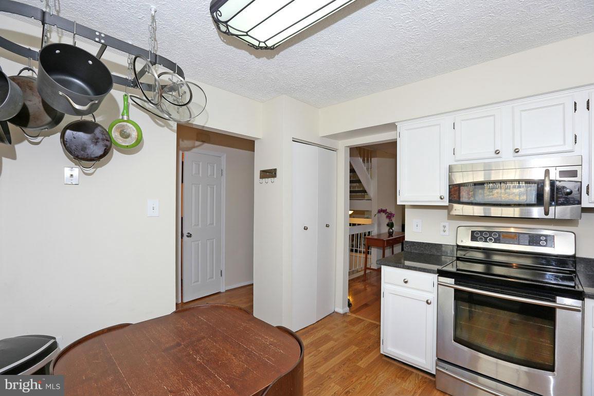 1816 Windjammer Way Gaithersburg, MD 20879 - Photo 6 of 29 a kitchen with stainless steel appliances and wooden floor