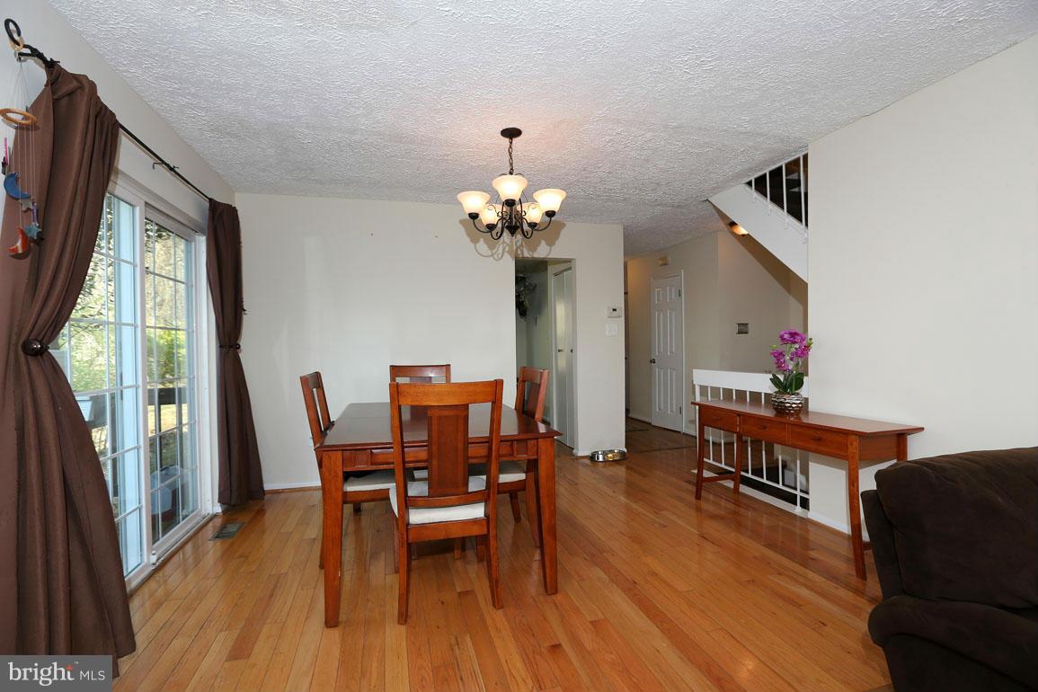 1816 Windjammer Way Gaithersburg, MD 20879 - Photo 8 of 29 a dining room with furniture potted plants and wooden floor