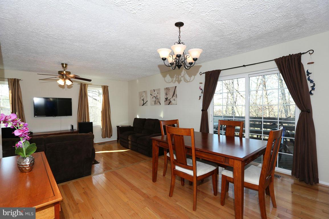 1816 Windjammer Way Gaithersburg, MD 20879 - Photo 9 of 29 a view of a dining room with furniture window and wooden floor