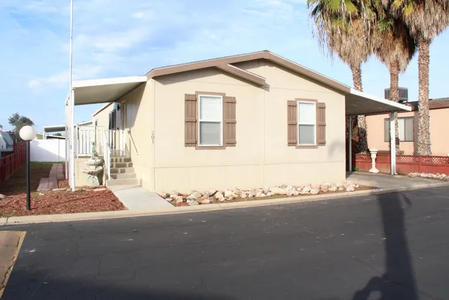 a front view of a house with a road
